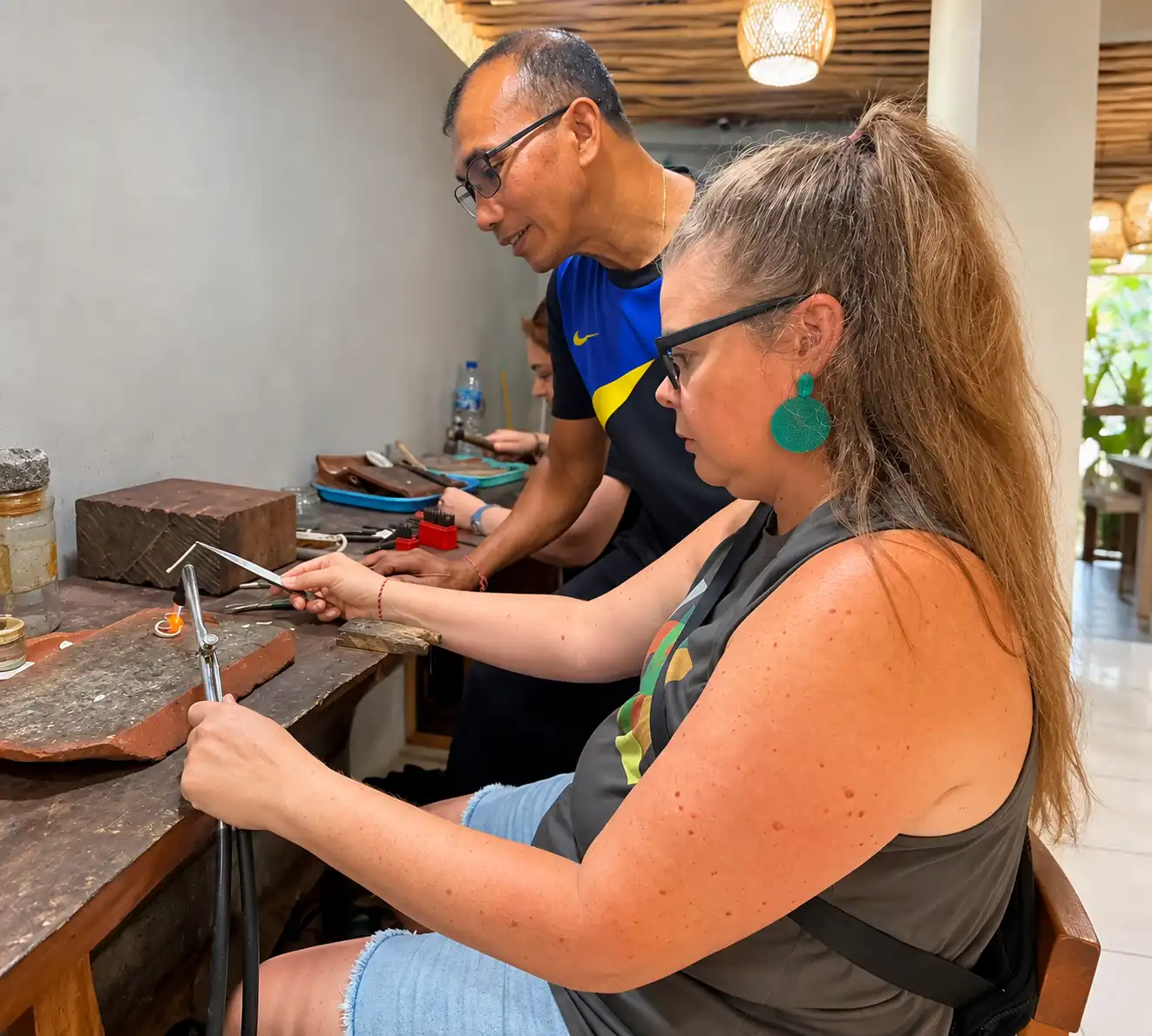 Guests making silver jewelry during a workshop in Ubud Bali
